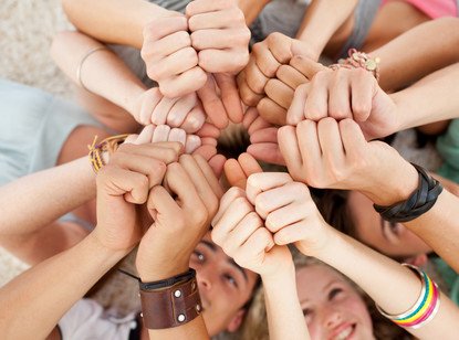 Smiling Teens With Hands Together
